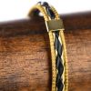 Bracelet en capim dourado et cuir noir